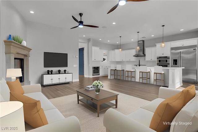 2805 Proust Ct, Henderson, NV 89044 - living area with a ceiling fan, light wood finished floors, recessed lighting, and a premium fireplace