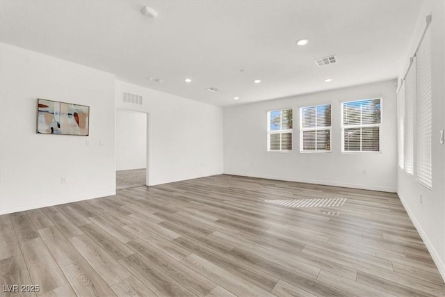 unfurnished room featuring light wood finished floors, visible vents, and recessed lighting