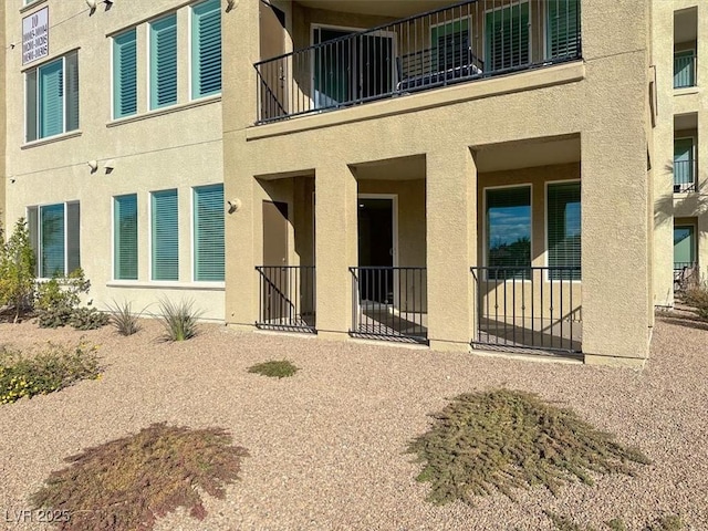 rear view of house with stucco siding