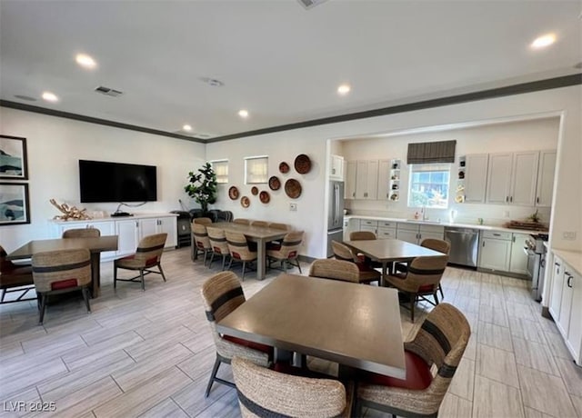 dining space with ornamental molding, visible vents, recessed lighting, and wood tiled floor