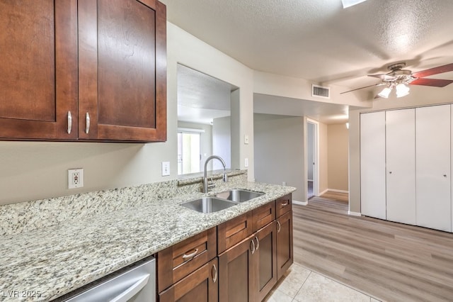 2120 Ramrod Ave Unit 2216, Henderson, NV 89014 - kitchen featuring ceiling fan, light stone countertops, visible vents, dishwasher, and a sink