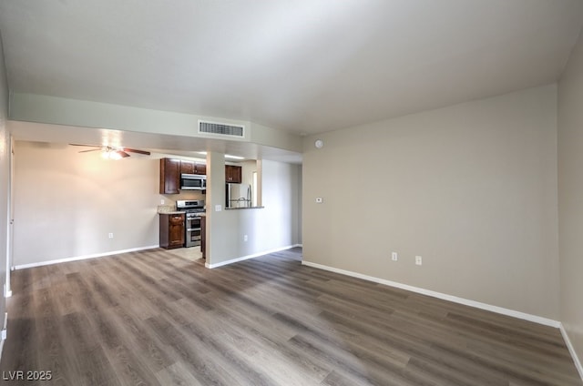 2120 Ramrod Ave Unit 2216, Henderson, NV 89014 - unfurnished living room with dark wood-type flooring, visible vents, and baseboards