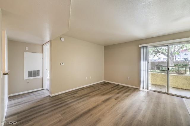2120 Ramrod Ave Unit 2216, Henderson, NV 89014 - spare room with visible vents, baseboards, wood finished floors, and a textured ceiling