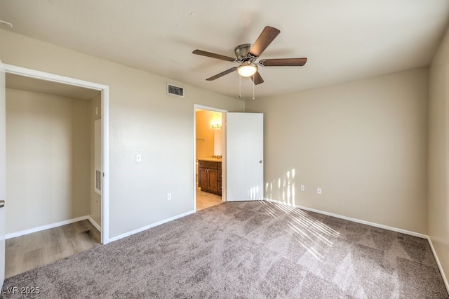 2120 Ramrod Ave Unit 2216, Henderson, NV 89014 - unfurnished bedroom featuring visible vents, baseboards, a ceiling fan, connected bathroom, and light carpet