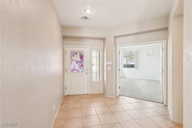 3029 Paseo Hills Way, Henderson, NV 89052 - foyer featuring light tile patterned floors, baseboards, a textured wall, and light colored carpet