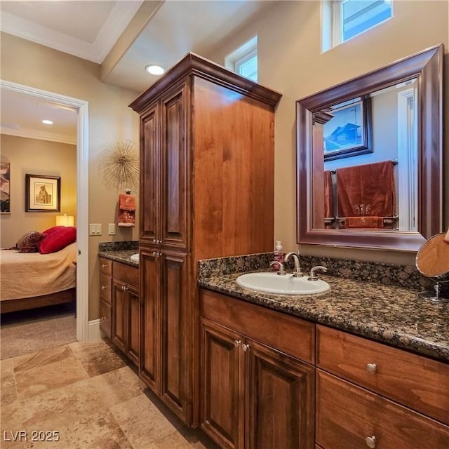 ensuite bathroom with vanity, crown molding, and recessed lighting