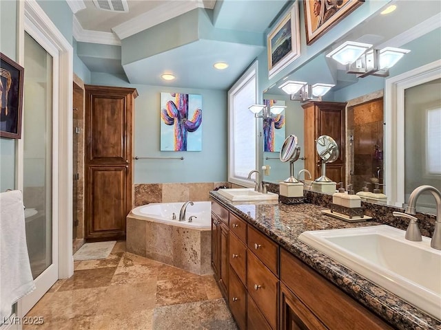 bathroom with a stall shower, crown molding, a bath, stone finish flooring, and double vanity