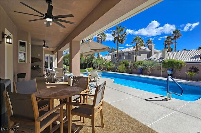 view of pool with ceiling fan, a patio area, outdoor dining area, and a fenced backyard