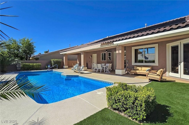 view of pool featuring an outdoor hangout area, a patio area, french doors, and fence