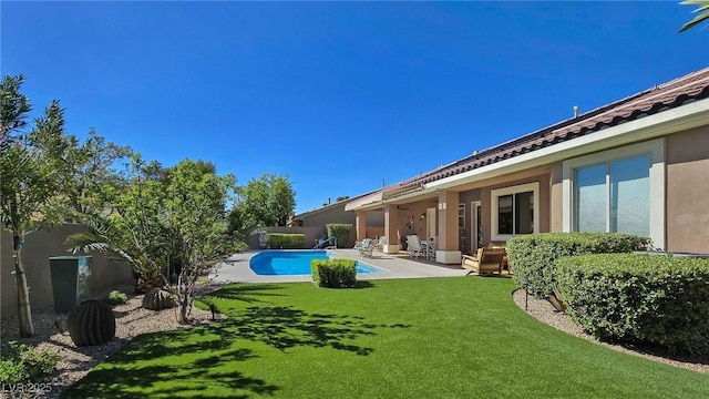 view of swimming pool with a yard and a patio area