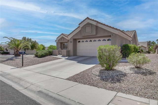 8801 Villa Ridge Dr, Las Vegas, NV 89134 - ranch-style house featuring a tile roof, an attached garage, driveway, and stucco siding