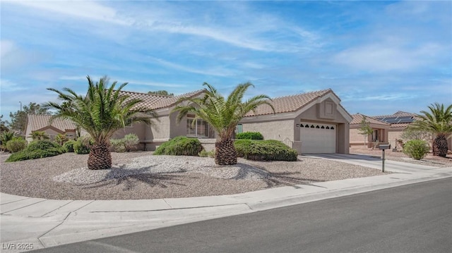 8801 Villa Ridge Dr, Las Vegas, NV 89134 - view of front of home with an attached garage, stucco siding, and a tile roof