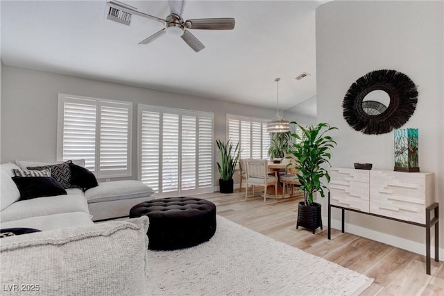 8801 Villa Ridge Dr, Las Vegas, NV 89134 - living area featuring visible vents, light wood-style flooring, a ceiling fan, and vaulted ceiling