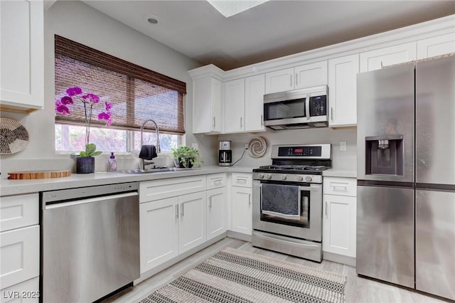 8801 Villa Ridge Dr, Las Vegas, NV 89134 - kitchen with a sink, light countertops, and appliances with stainless steel finishes