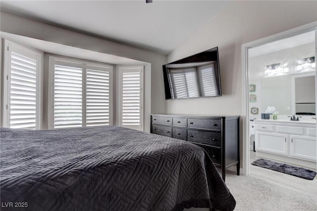 8801 Villa Ridge Dr, Las Vegas, NV 89134 - bedroom with light colored carpet, a sink, and lofted ceiling