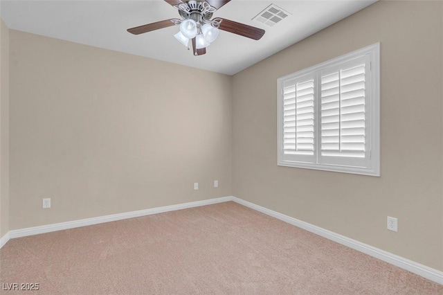 carpeted empty room featuring visible vents, ceiling fan, and baseboards