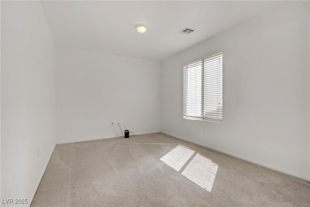 carpeted spare room with baseboards and visible vents