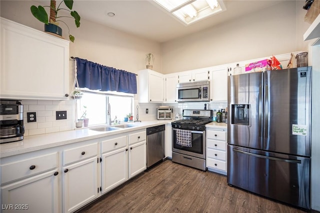 7103 Shadow Crest Dr, Las Vegas, NV 89119 - kitchen with appliances with stainless steel finishes, a sink, and white cabinets