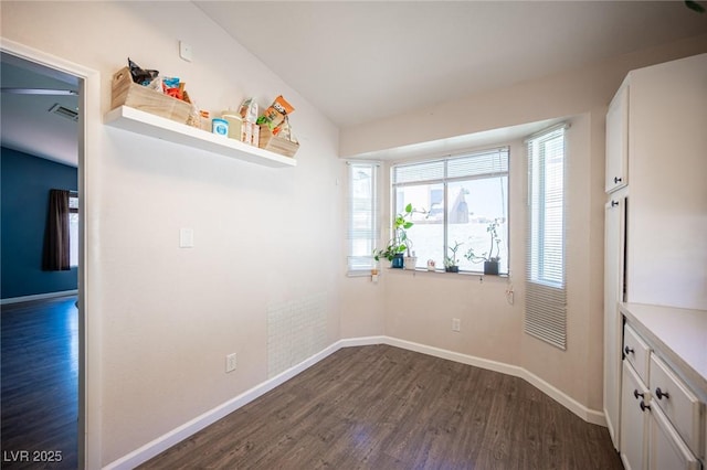 7103 Shadow Crest Dr, Las Vegas, NV 89119 - unfurnished dining area featuring dark wood-style flooring and baseboards