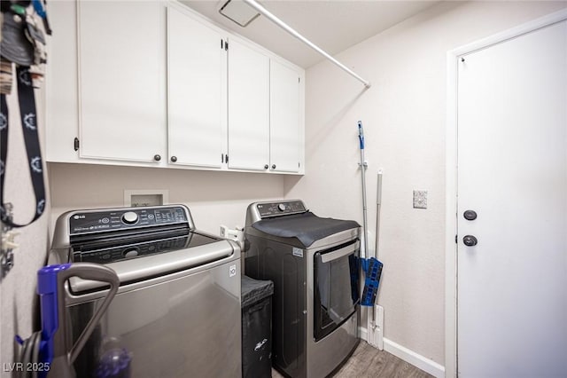 7103 Shadow Crest Dr, Las Vegas, NV 89119 - clothes washing area featuring washer and dryer, cabinet space, wood finished floors, and baseboards