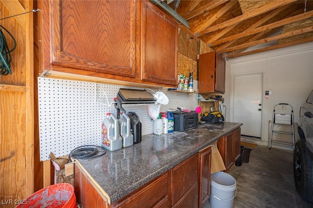 7103 Shadow Crest Dr, Las Vegas, NV 89119 - kitchen featuring lofted ceiling, brown cabinetry, and decorative backsplash