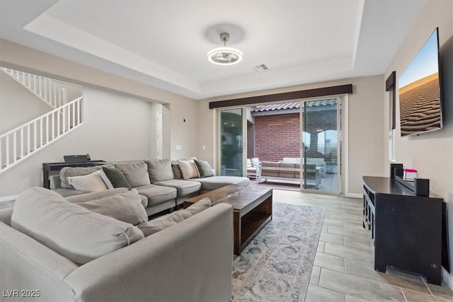 342 Molinetto St, Las Vegas, NV 89138 - living room with stairway, visible vents, a tray ceiling, and a healthy amount of sunlight