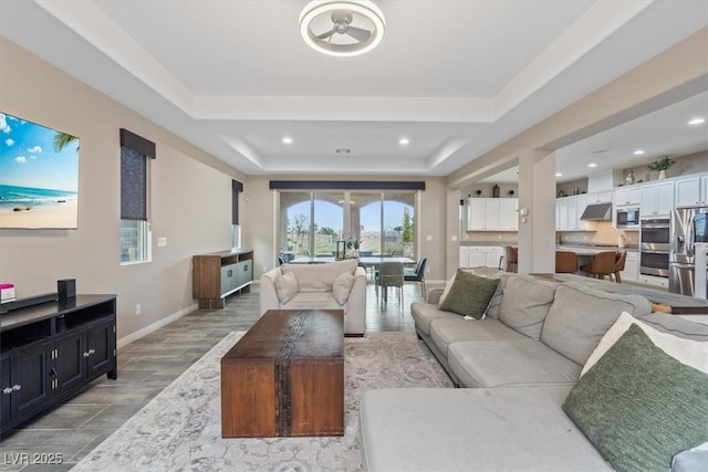 342 Molinetto St, Las Vegas, NV 89138 - living area with recessed lighting, baseboards, a raised ceiling, and light wood-style floors