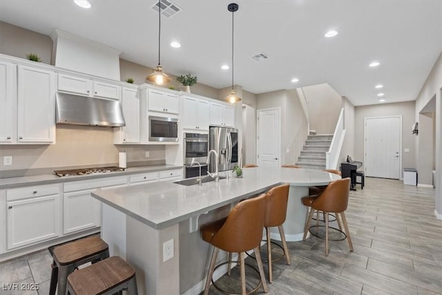 342 Molinetto St, Las Vegas, NV 89138 - kitchen featuring white cabinets, under cabinet range hood, visible vents, and appliances with stainless steel finishes