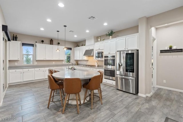 342 Molinetto St, Las Vegas, NV 89138 - kitchen featuring under cabinet range hood, a healthy amount of sunlight, visible vents, and stainless steel appliances