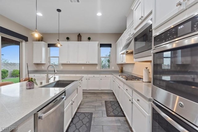 342 Molinetto St, Las Vegas, NV 89138 - kitchen with recessed lighting, light countertops, white cabinets, stainless steel appliances, and a sink