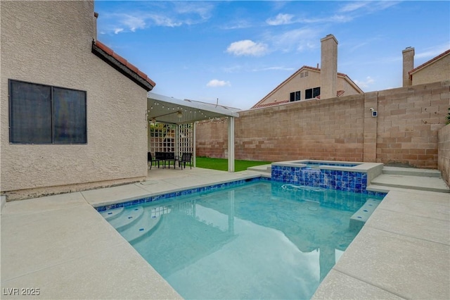 view of pool featuring a fenced backyard, an in ground hot tub, a fenced in pool, and a patio