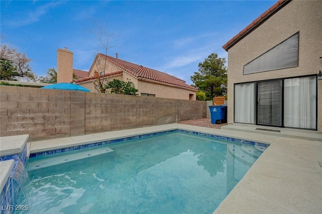 view of swimming pool with a fenced backyard