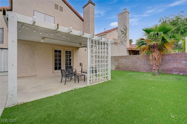 view of yard featuring french doors, fence, and a patio