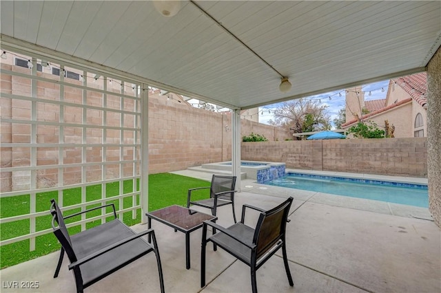 view of patio with a fenced backyard and a pool with connected hot tub