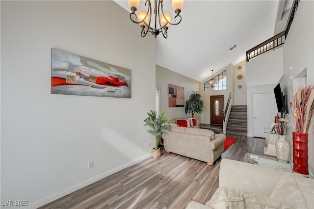 living room featuring high vaulted ceiling, visible vents, stairway, wood finished floors, and a notable chandelier