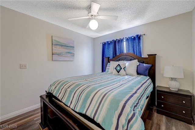 bedroom with baseboards, ceiling fan, wood finished floors, and a textured ceiling
