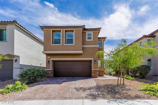 view of front facade with a garage, stucco siding, stone siding, and decorative driveway