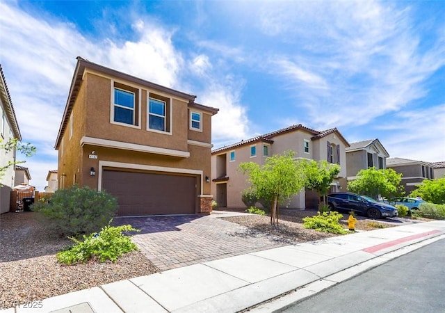 traditional-style home with a residential view, driveway, stucco siding, and an attached garage