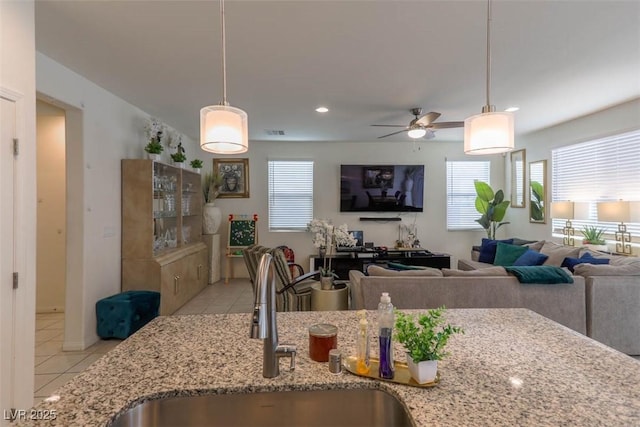 kitchen with a sink, light tile patterned floors, a ceiling fan, and recessed lighting