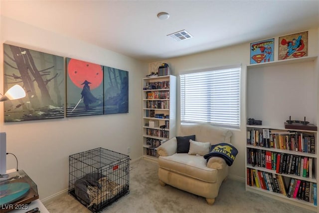 living area featuring visible vents, baseboards, and carpet