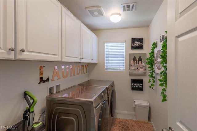 clothes washing area with cabinet space, visible vents, baseboards, and separate washer and dryer