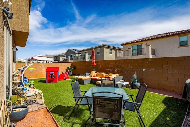 view of yard featuring an outdoor hangout area, a residential view, a fenced backyard, a patio, and outdoor dining area