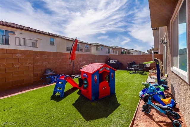 view of jungle gym featuring a yard and a fenced backyard