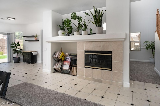 6973 Pacific Coast St, Las Vegas, NV 89148 - carpeted living area featuring a tiled fireplace and baseboards