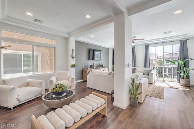 living room featuring visible vents, baseboards, a ceiling fan, and wood finished floors
