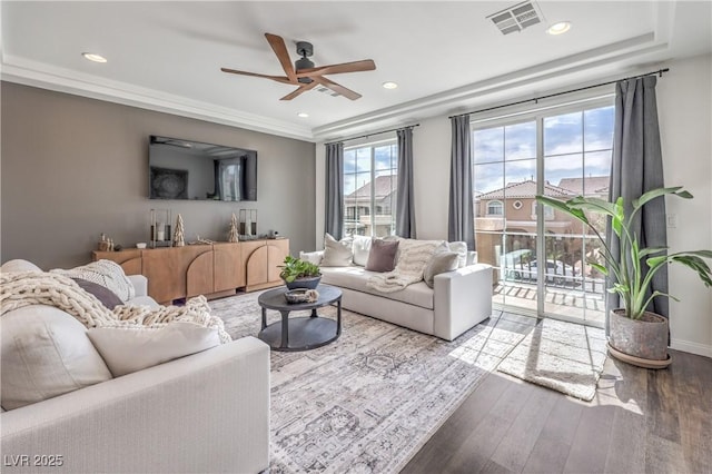 living room with recessed lighting, visible vents, wood finished floors, a raised ceiling, and ceiling fan