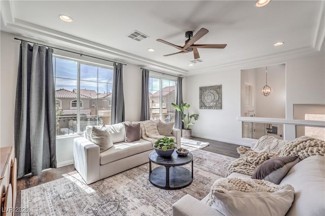 living area featuring wood finished floors, ceiling fan, visible vents, and recessed lighting