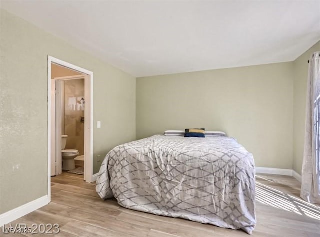 bedroom featuring wood finished floors and baseboards