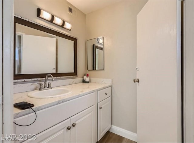 bathroom featuring vanity and baseboards