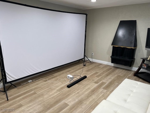 cinema room with light wood-type flooring, baseboards, and recessed lighting